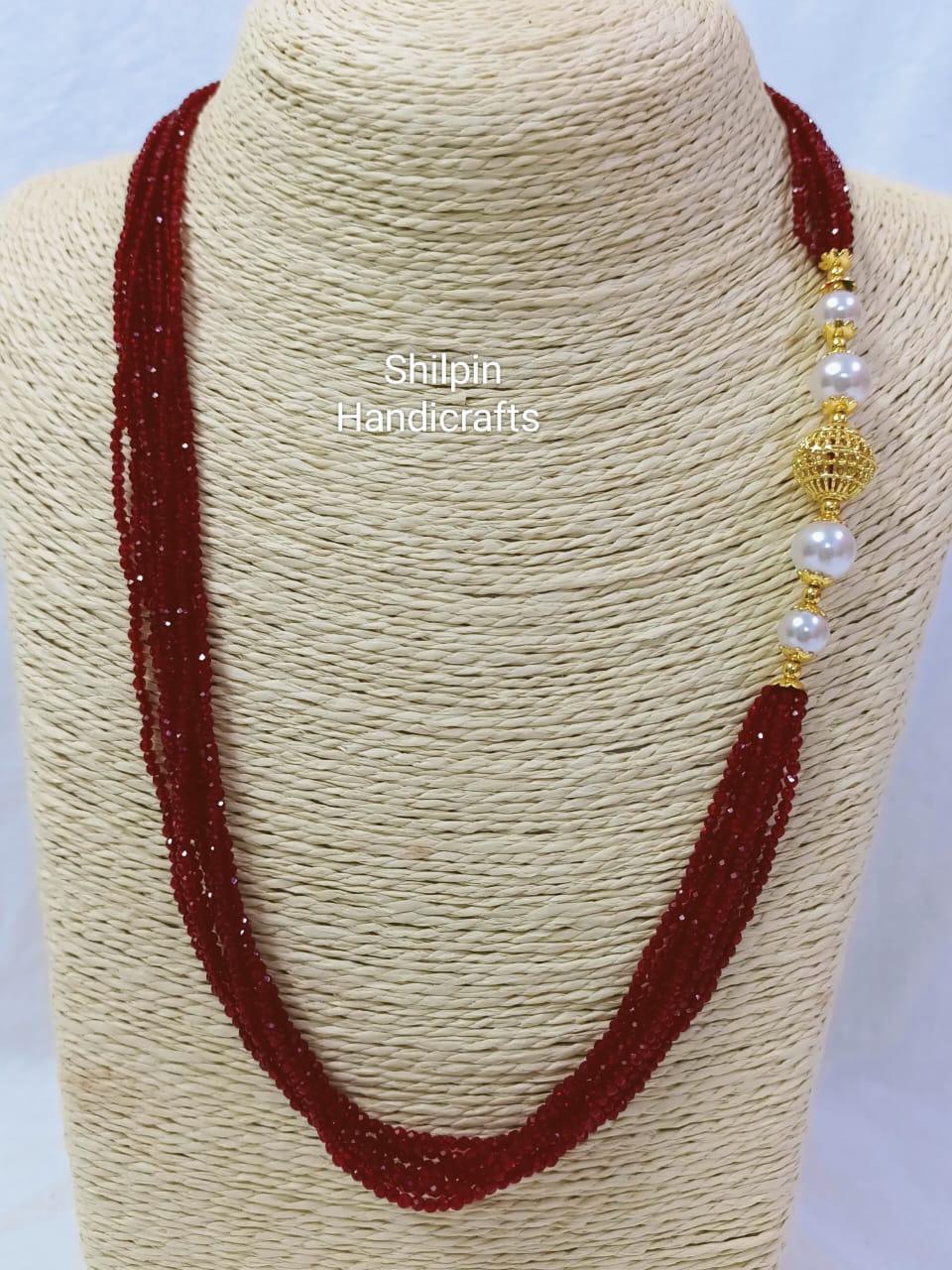 Elegant Red Crystal Necklace with Golden Accents and Pearls